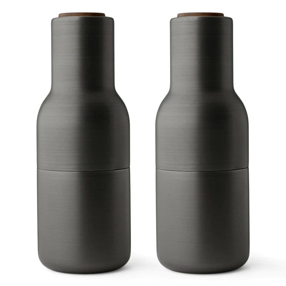 Menu Bottle Grinder Set -Brushed Brass with Walnut Lid. The form, shaped more like a bottle, cleverly tricks the user to encourage a more playful and experimental interaction with the product.