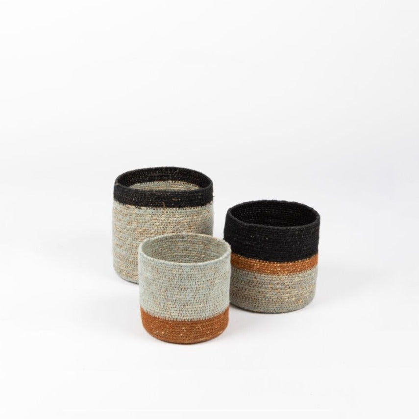 The Paco Basket Set in sea foam/black/paprika  is a perfect way to store objects around the home in style. Functional, beautiful and textural.  Handwoven in India from natural seagrass and cotton to make a stronger finish, these tight-weave baskets are a playful and charming addition to your home.